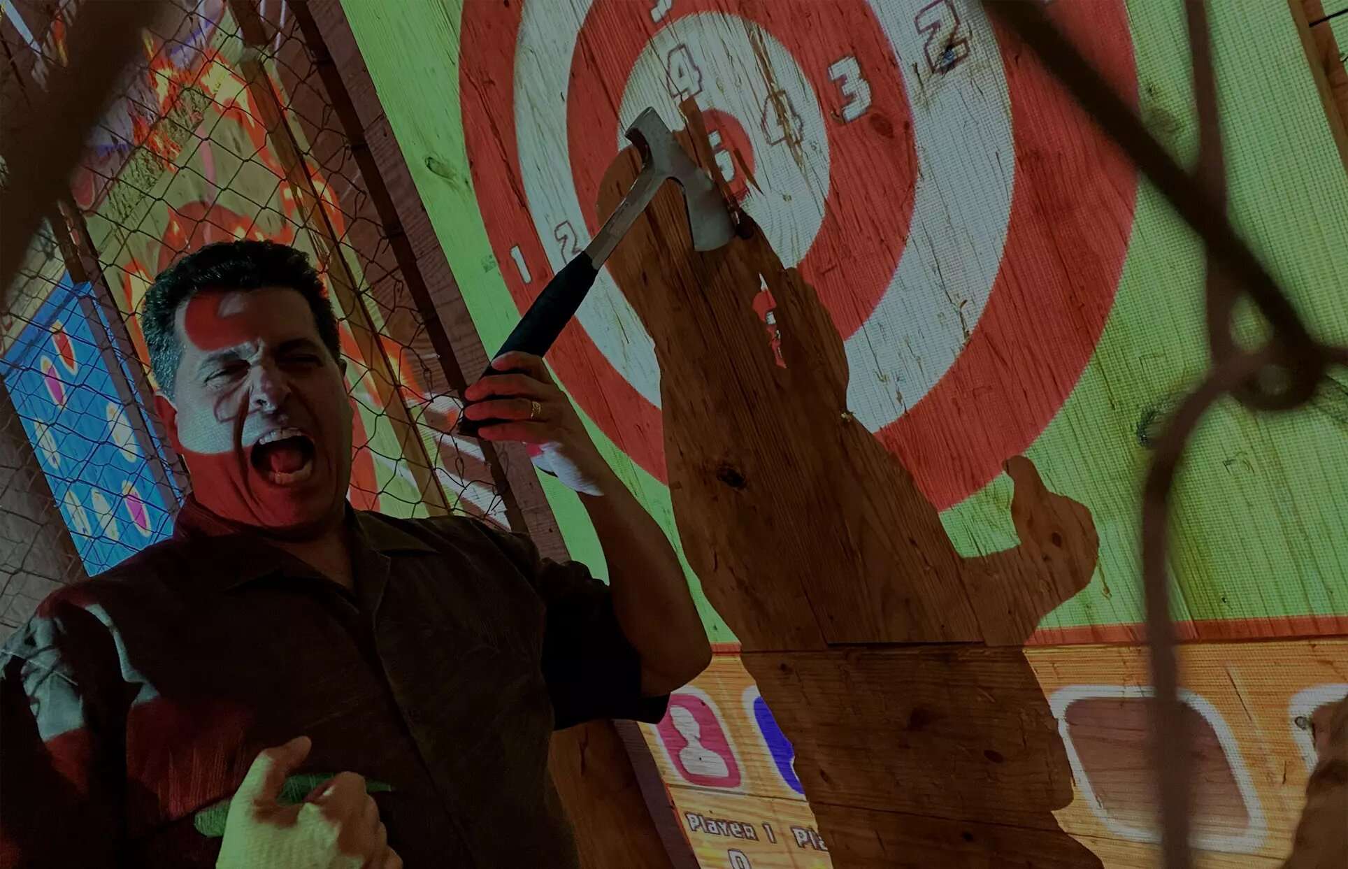 Man axe throwing at digital target in Hollywood Florida