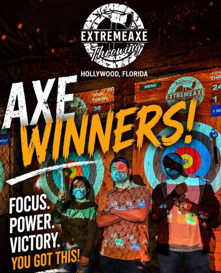 Group of friends celebrating axe throwing wins in front of targets at Extreme Axe Throwing Hollywood Florida