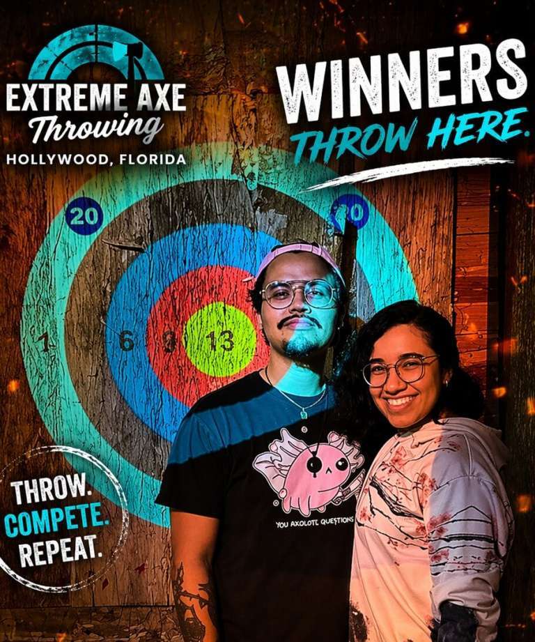 Couple smiling after a successful axe throw at Extreme Axe Throwing Hollywood Florida