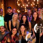 Happy group of friends posing together at Extreme Axe Throwing in Hollywood Florida, enjoying a fun and social indoor activity