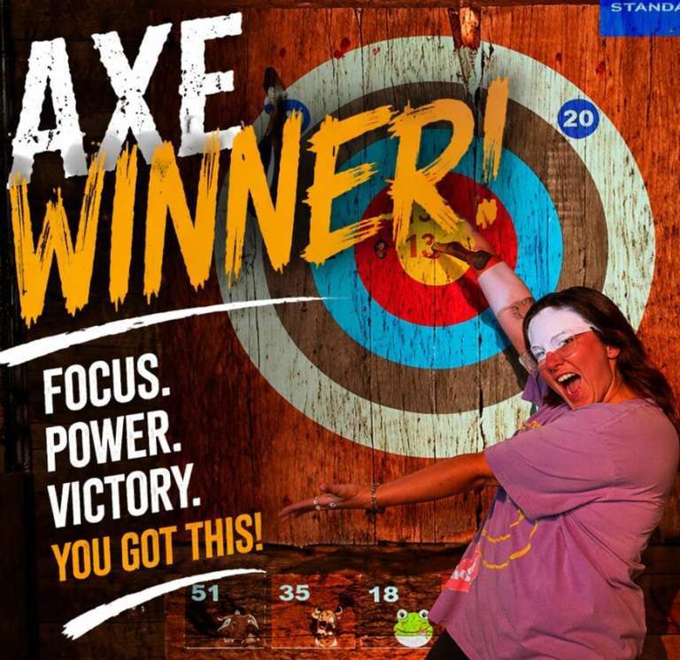 Woman celebrating a winning axe throw while pointing at the bullseye target at Extreme Axe Throwing Hollywood Florida
