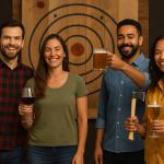 Four friends enjoying drinks and holding axes at an indoor axe throwing venue in Hollywood, Florida.