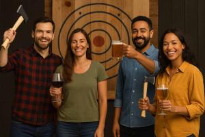 Four friends enjoying drinks and holding axes at an indoor axe throwing venue in Hollywood, Florida.