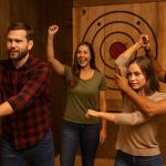 Group of adults participating in axe throwing with instructor guidance at an indoor range in Hollywood, FL.