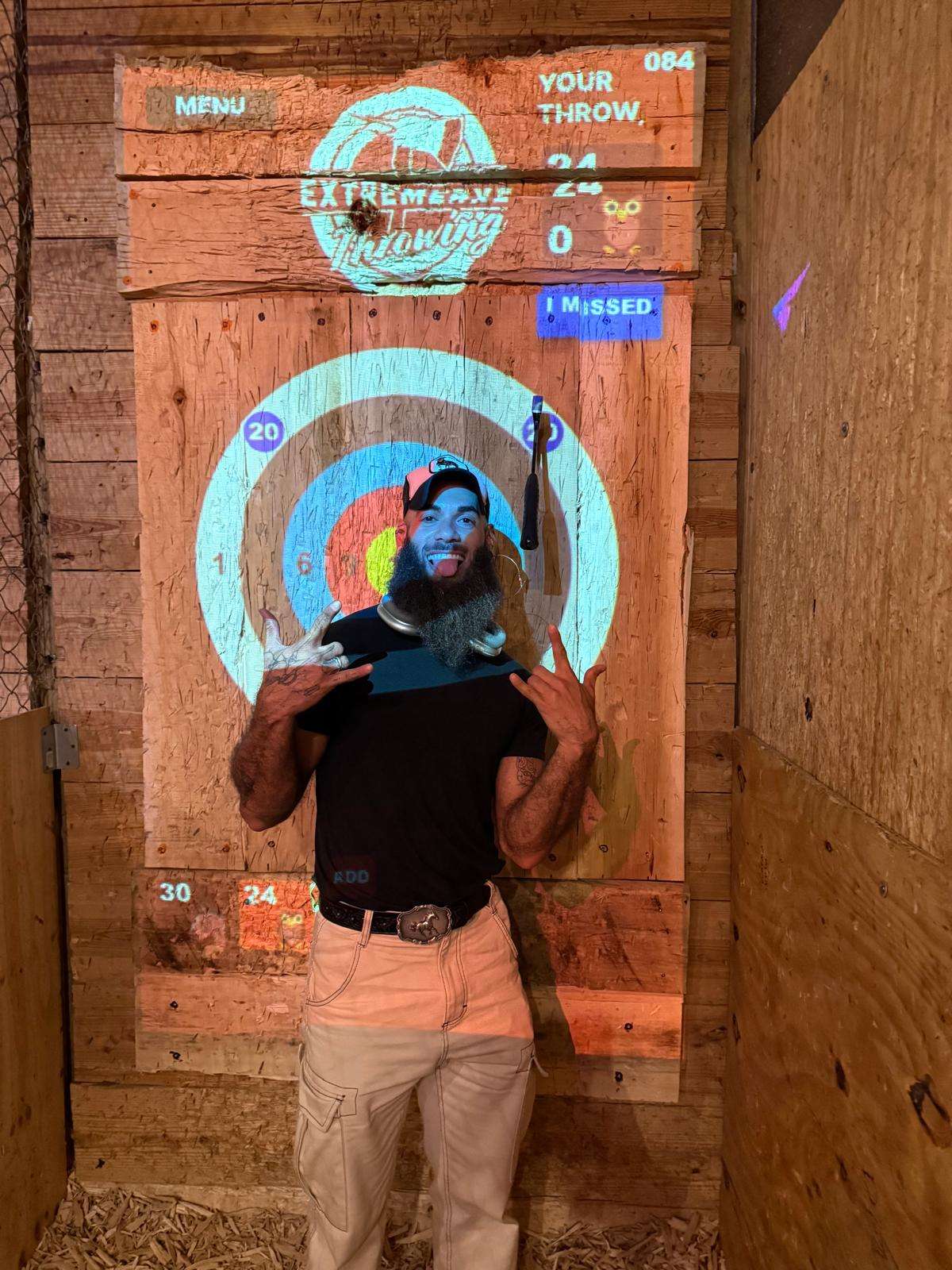 Player aiming at interactive axe throwing target at Extreme Axe Throwing Hollywood