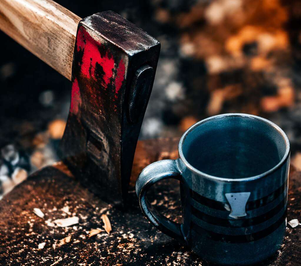 Close up of axe and mug at Extreme Axe Throwing Hollywood Florida rustic throwing experience