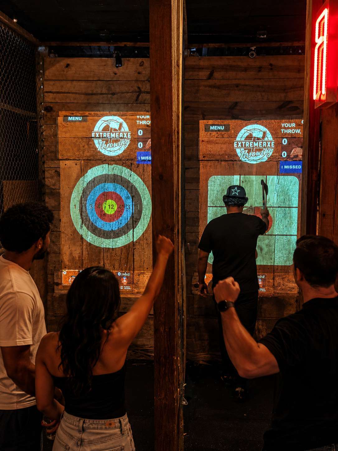 Adults enjoying indoor axe throwing nightlife activity at Extreme Axe Throwing Hollywood in Florida
