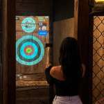 Woman enjoying indoor axe throwing at Extreme Axe Throwing Hollywood near Fort Lauderdale